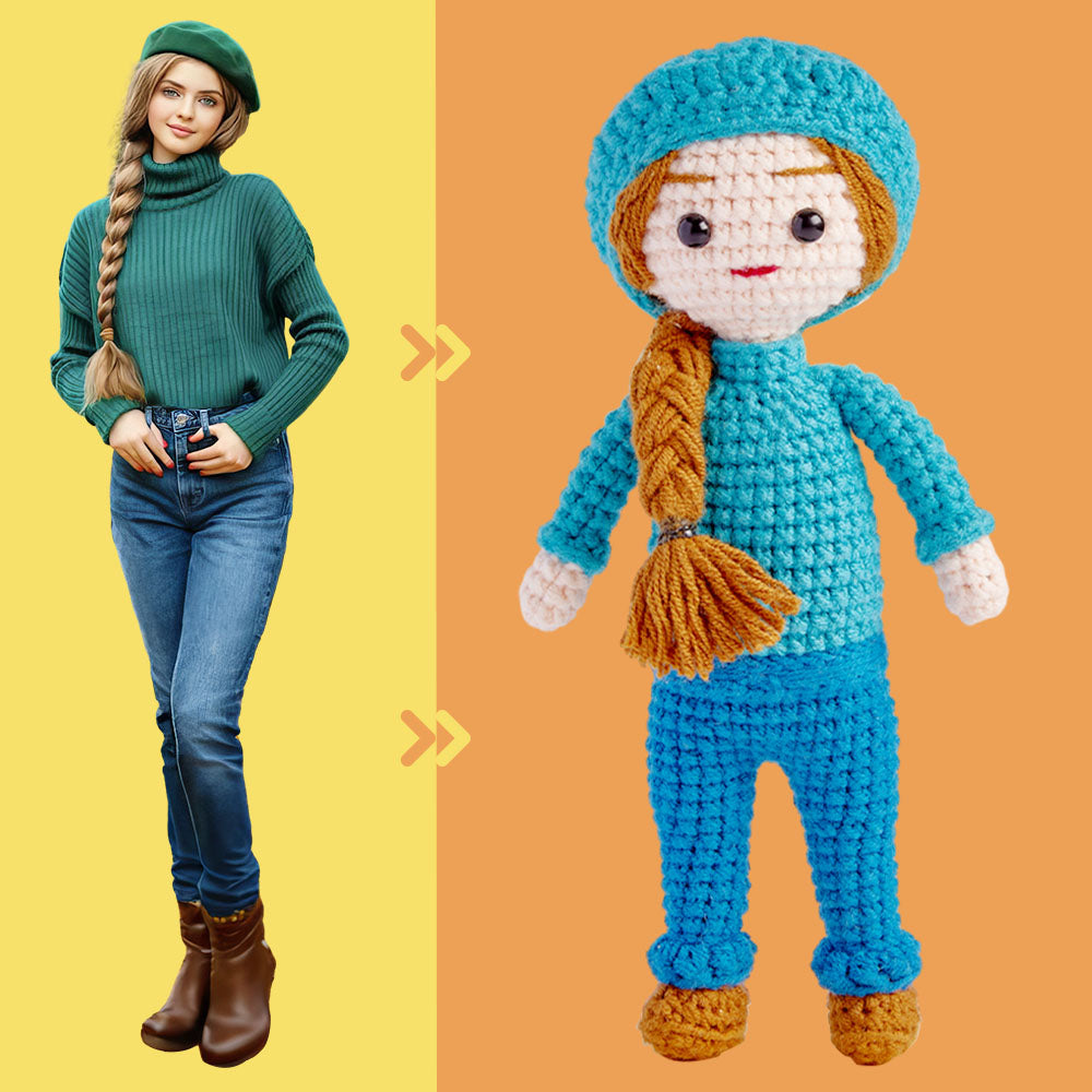 A woman in a green turtleneck and jeans stands next to a crochet doll replica of herself against a split yellow/orange background.