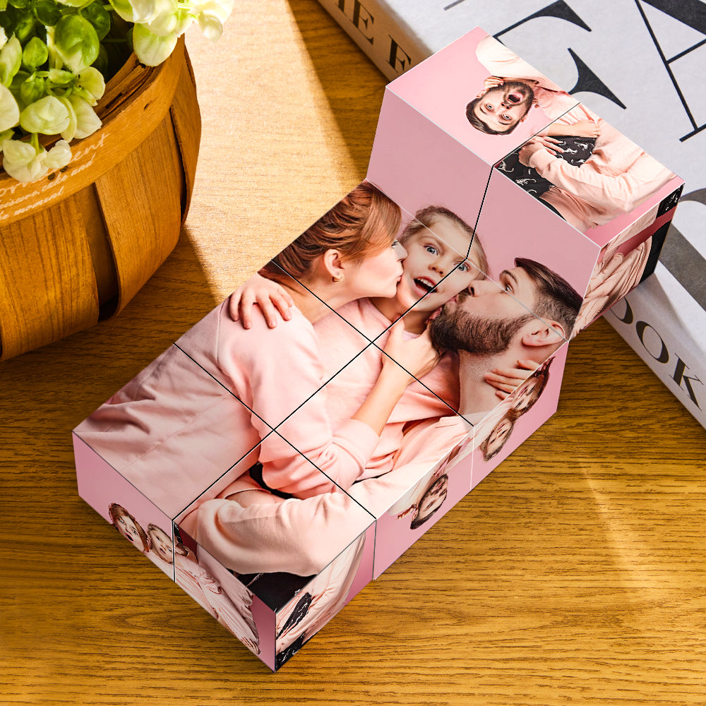 Personalized photo cube with images of a family, displayed on a wooden table next to green plant and books.