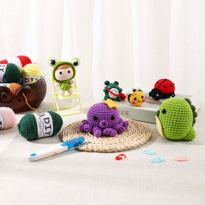 Alt text: A collection of colorful crocheted amigurumi toys, including animals and an octopus, displayed among yarn balls and crochet hooks on a woven mat with a subtle curtain background.