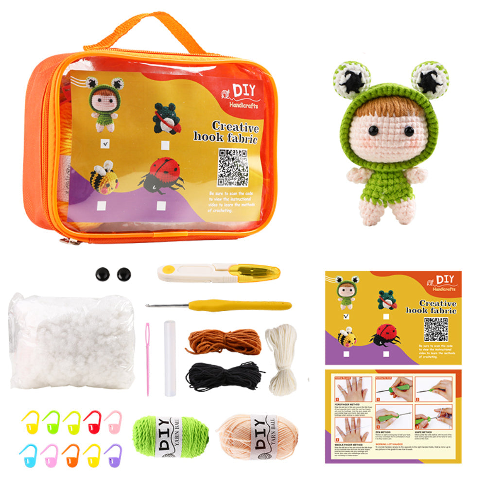 A crochet kit with colorful yarns, hooks, stuffing, safety eyes, stitch markers, and instructions, plus a finished crochet doll dressed as a frog.