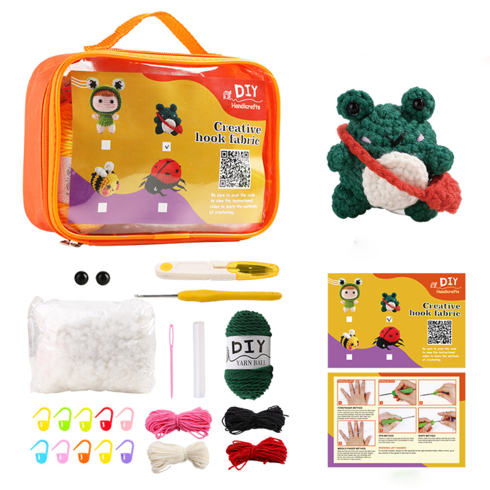 Alt text: DIY crochet kit with orange bag, yarn, crochet hooks, stuffing, safety eyes, clips, step-by-step guide, and a completed crocheted frog plush.